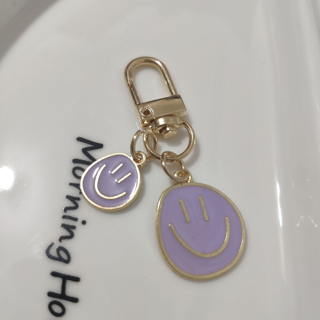 Cross-border e-commerce alloy color dripping smiley face keychain electroplated gold irregular expression bag pendant accessories
