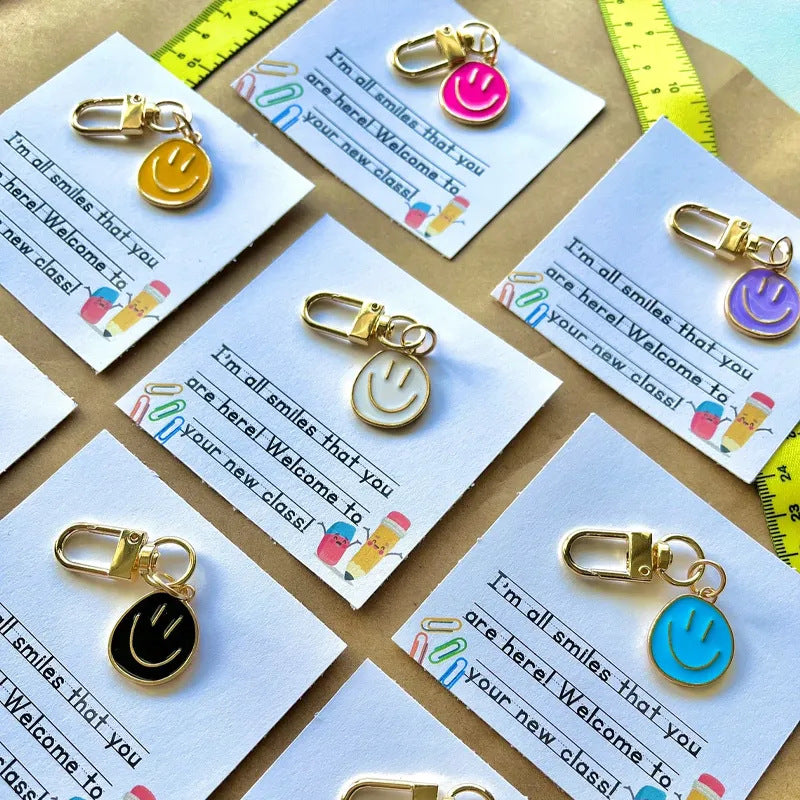 Cross-border e-commerce alloy color dripping smiley face keychain electroplated gold irregular expression bag pendant accessories