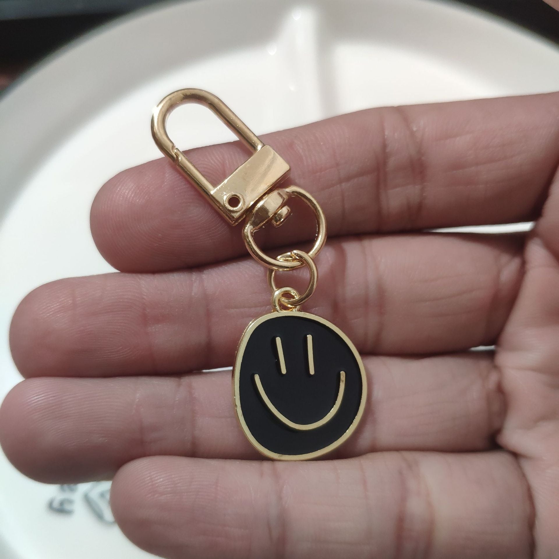 Cross-border e-commerce alloy color dripping smiley face keychain electroplated gold irregular expression bag pendant accessories